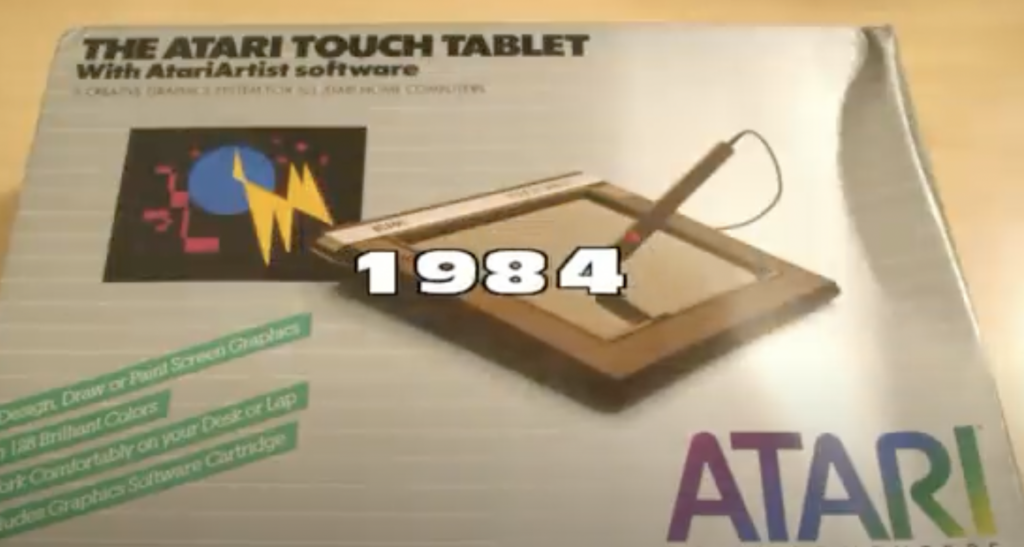 A box of the Atari Touch Tablet with AtariArtist software from 1984. The front features an illustration of the tablet and stylus, with colorful graphics and the Atari logo.