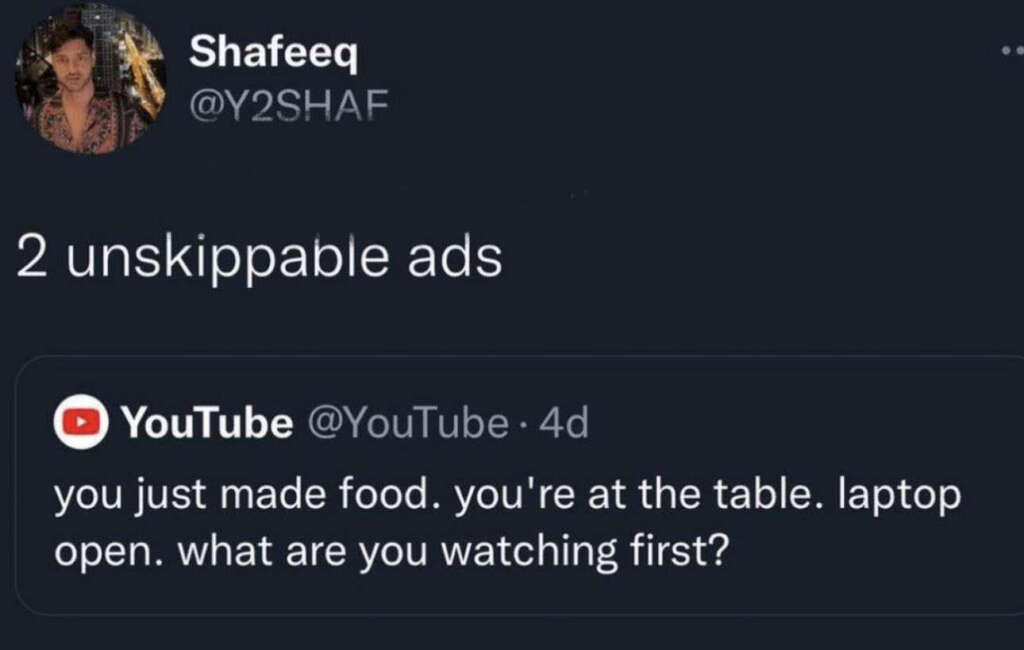 Screenshot of a tweet by @Y2SHAF. The tweet reads: "2 unskippable ads" in response to a YouTube tweet saying, "you just made food. you're at the table. laptop open. what are you watching first?