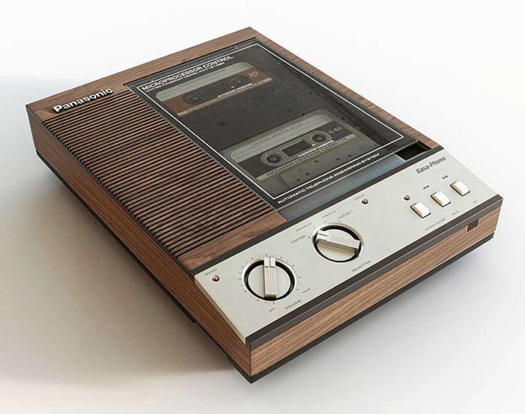 Vintage Panasonic cassette tape player and recorder with a woodgrain finish. Features include large dials, buttons, and a clear window showing an inserted cassette tape.