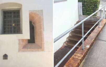 The image is divided into two sections. The left shows a barred window set in a white wall with a small opening. The right section shows stairs partially blocked by a brick wall, with a handrail on the opposite side.