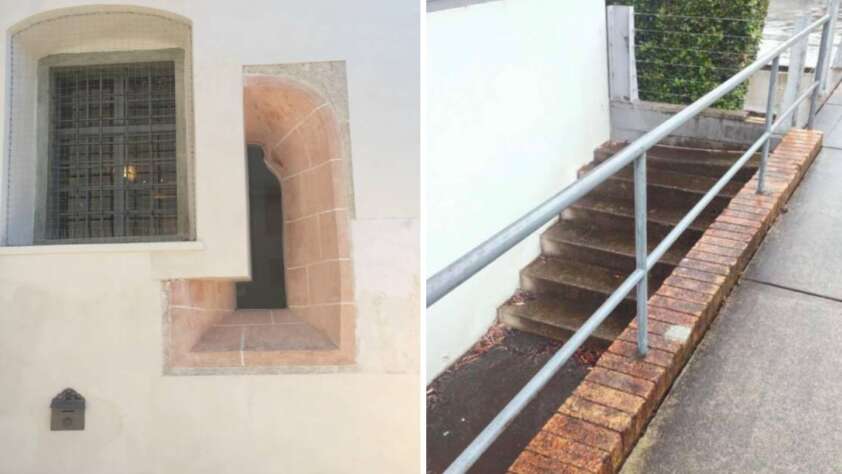 The image is divided into two sections. The left shows a barred window set in a white wall with a small opening. The right section shows stairs partially blocked by a brick wall, with a handrail on the opposite side.