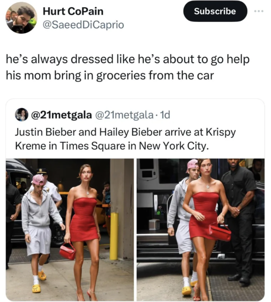 A tweet shows Justin and Hailey Bieber walking outside. Justin wears casual clothes and a cap, while Hailey wears a red dress. The caption humorously comments on their attire in relation to helping with groceries.