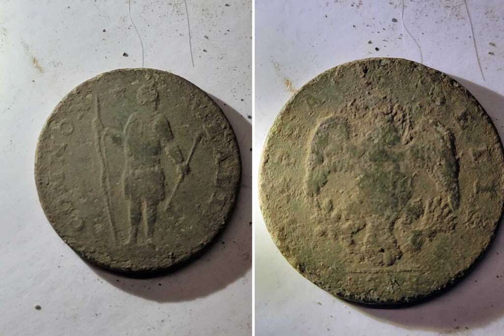 Two images of an old, weathered coin are side by side. The left image shows one side with a figure holding a staff. The right image shows an eagle with spread wings. The coin appears to be made of a dull, oxidized material.