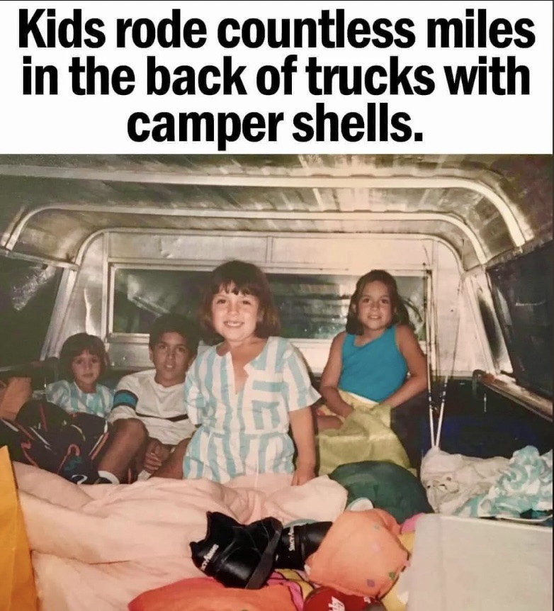 Four children sit inside the bed of a truck with a camper shell. They are surrounded by blankets and smiling. Text above the image reads, "Kids rode countless miles in the back of trucks with camper shells.