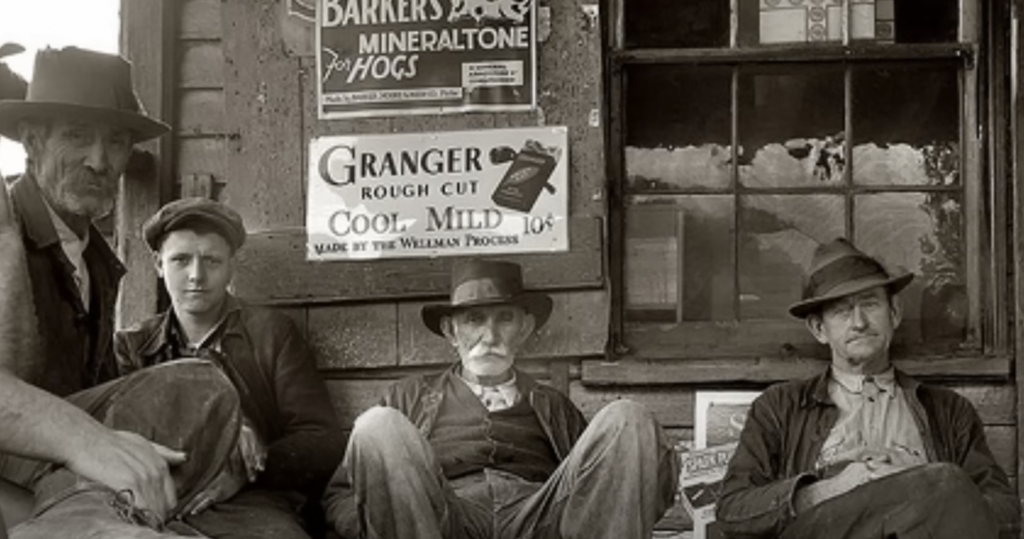 Four men in hats sit on a wooden bench outside a building with worn-looking walls. Behind them are vintage advertisements for products including "Granger Rough Cut." The scene conveys a rustic, bygone-era atmosphere.