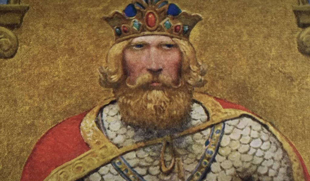 A painting of a medieval king with a crown adorned with colorful jewels, long blond hair, and a beard. He wears ornate armor with a red cloak draped over his shoulders, set against a golden background.