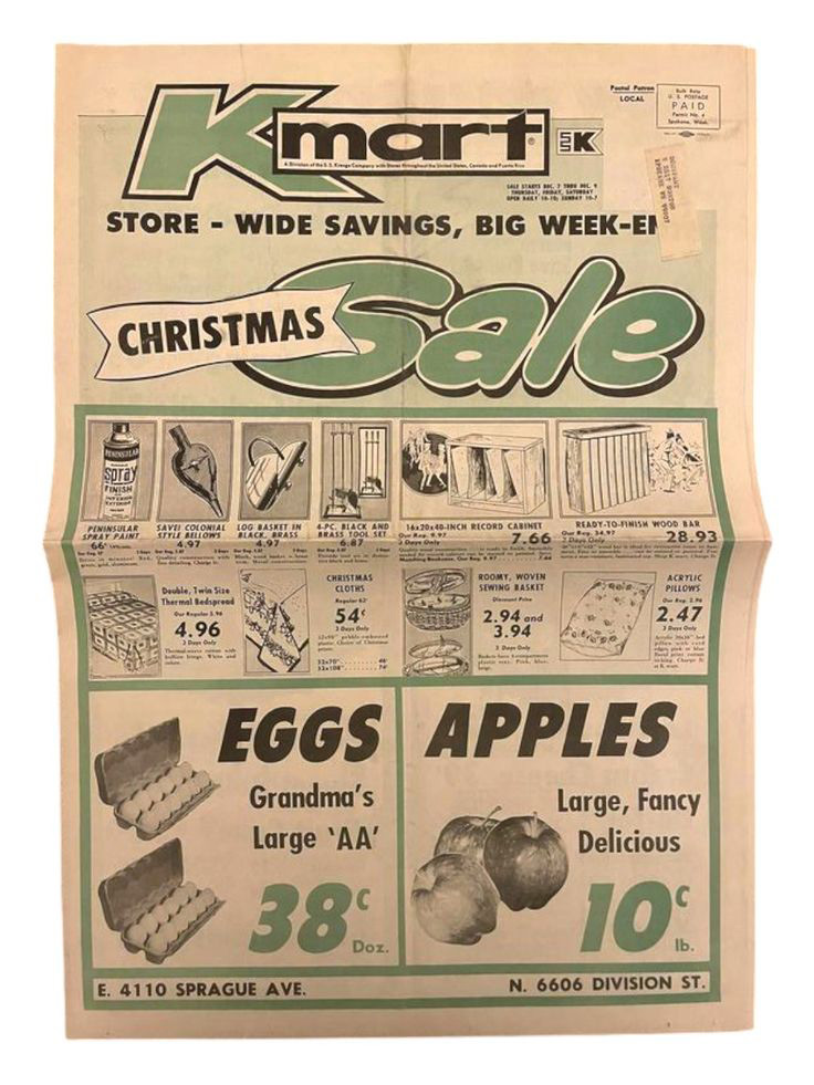 A vintage Kmart Christmas sale flyer featuring various products. At the top, it displays the Kmart logo and "Christmas Sale." The flyer advertises eggs for 38 cents a dozen and apples for 10 cents each. Other items and prices are listed.