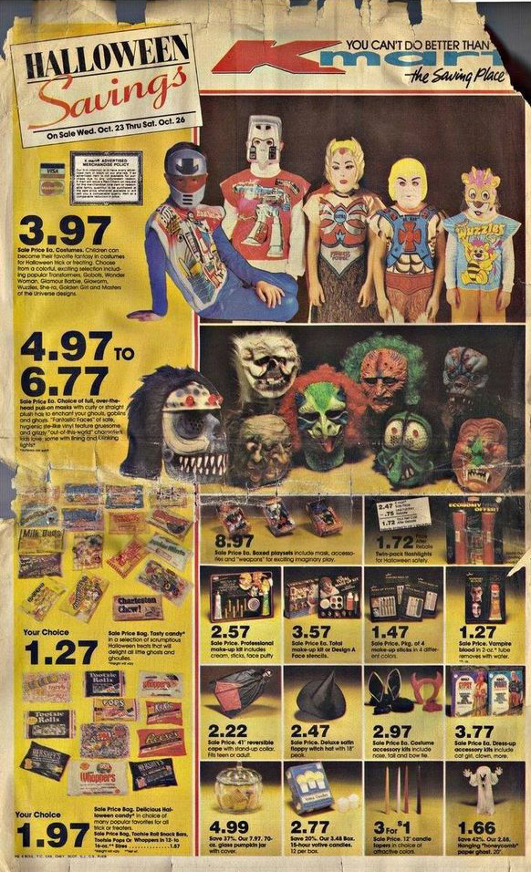 Vintage Halloween store advertisement featuring various costumes, including superheroes and monsters, with prices ranging from $1.27 to $6.77. The ad displays a mix of masks, candy, and decorations on a yellowed, aged paper background.