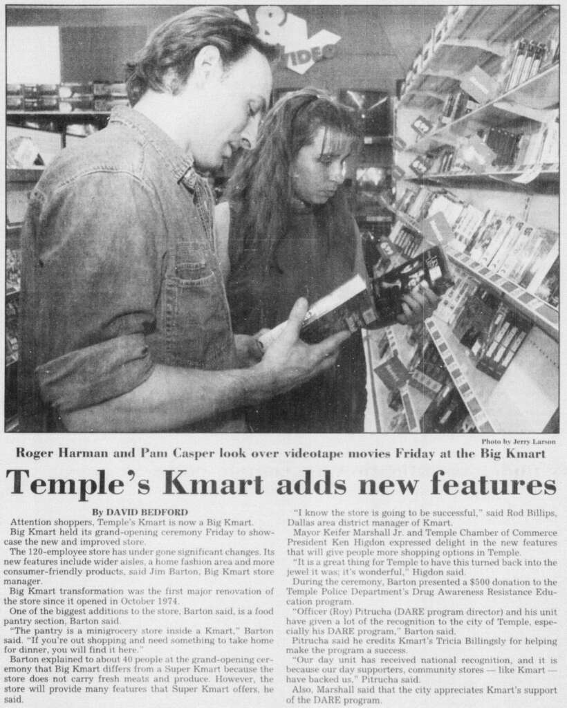 A man and woman browse videotapes on a store shelf. The article headline reads "Temple's Kmart adds new features." The caption mentions Roger Harman and Pam Casper in the Kmart store. The text discusses updates to the Temple Kmart.