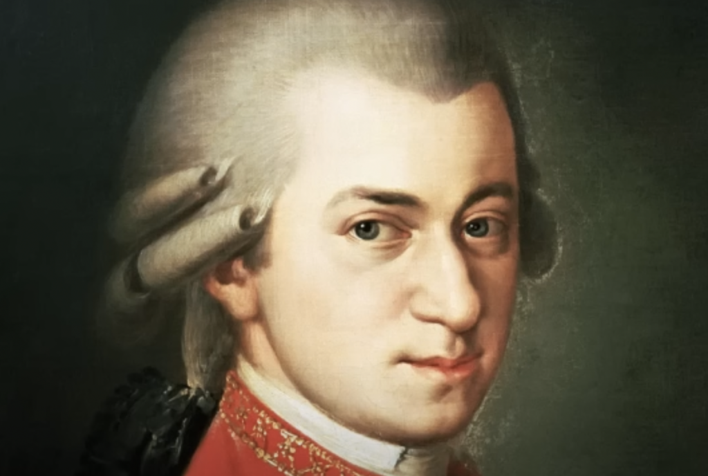 Portrait of a man with a powdered wig, wearing a red coat with a white collar. The background is dark, highlighting his face and attire.