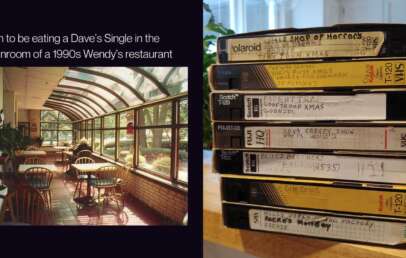 A 1990s Wendy's sunroom with wooden tables and chairs has sunlight streaming in through large windows. Next to it, a stack of labeled VHS tapes is arranged vertically, featuring various TV shows and movies.