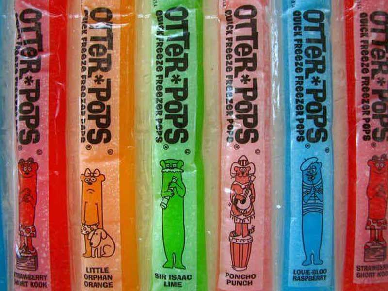 Colorful Otter Pops in a variety of flavors: Strawberry Short Kook, Little Orphan Orange, Sir Isaac Lime, Poncho Punch, and Louie-Bloo Raspberry. Each flavor features a cartoon otter character on the packaging.