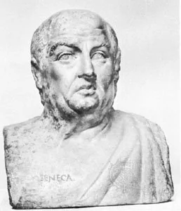 Black and white image of an ancient marble bust depicting a Roman man with short hair and a solemn expression. The bust shows a draped garment over his right shoulder and is inscribed with "Seneca" on the base.