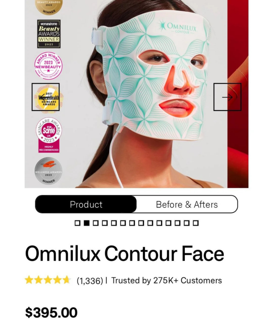 Image of a website displaying the Omnilux Contour Face mask. The product is shown on a person's face, featuring a patterned light therapy mask. It's priced at $395, with reviews and awards visible. Tabs for "Product" and "Before & Afters" are above.