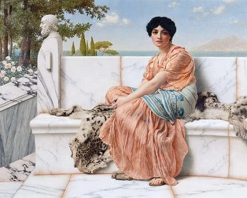 A woman in a flowing orange dress sits on a marble bench adorned with animal pelts. She gazes forward, with a serene landscape of trees and distant mountains in the background. A statue of a bearded figure is beside her.