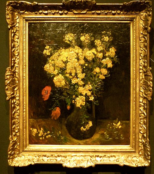 A classic painting in an ornate gold frame depicts a bouquet of yellow flowers with scattered red blossoms in a dark vase, set against a shadowy background.