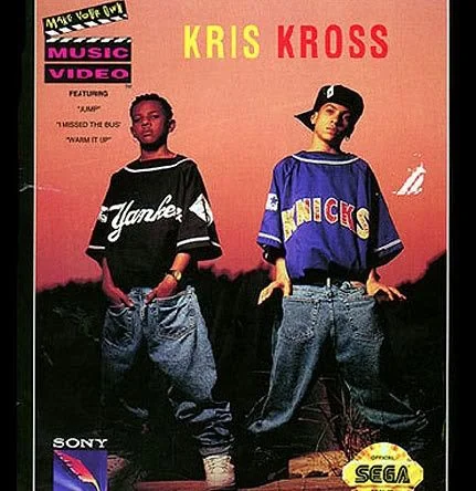 Two young men stand confidently wearing oversized Yankees and Knicks jerseys with baggy jeans. The background features a "Kriss Kross" logo and mentions music videos for "Jump," "I Missed the Bus," and "Warm It Up," alongside Sony and Sega logos.