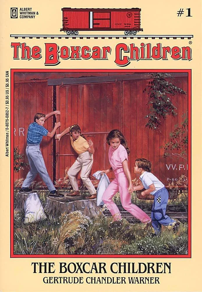 Cover of "The Boxcar Children" by Gertrude Chandler Warner. Four children are playing near a red boxcar, with one pushing the door open and the others watching eagerly. The background shows grass and trees.