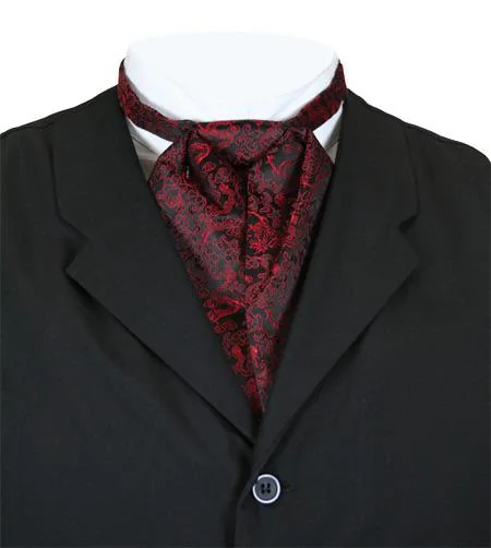 A close-up of a black suit jacket with a single button, featuring a dark red paisley ascot tie around a white shirt collar. The ascot has intricate patterns, adding elegance to the ensemble.