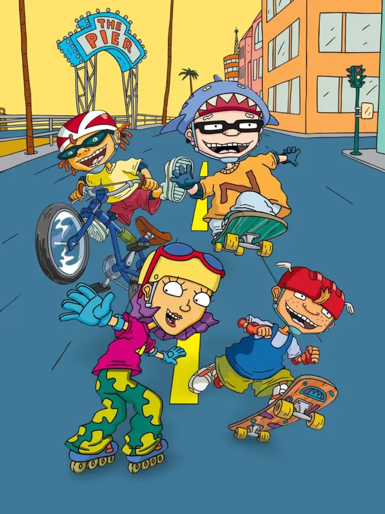 A colorful cartoon scene with four kids enjoying extreme sports near the beach. One is on a bike, another on skates, and two are skateboarding. A sign reading "The Pier" is visible in the background with buildings and a palm tree.