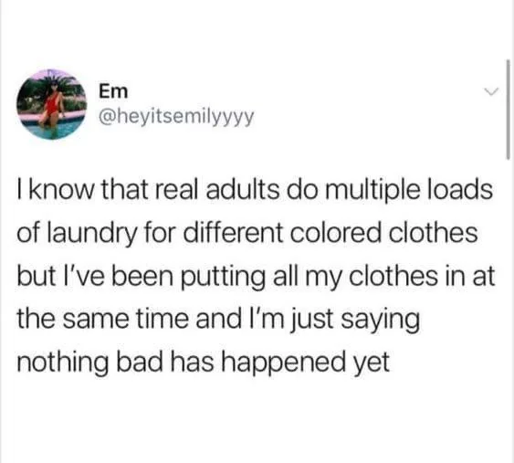 A tweet from user Em (@heyitsemilyyyy) humorously states that although adults do separate laundry loads by color, she puts all her clothes together and has faced no issues.