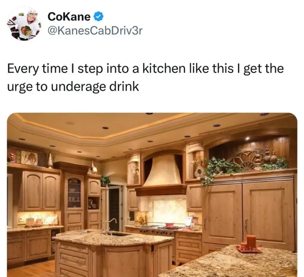 A tweet showing a luxurious wooden kitchen with ornate cabinets and a large island. The tweet reads, "Every time I step into a kitchen like this I get the urge to underage drink.