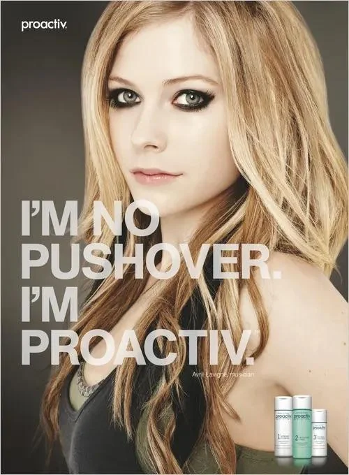 A woman with long blonde hair and dark eye makeup poses in a Proactiv advertisement. Text on the image reads, "I'm no pushover. I'm Proactiv." Three Proactiv bottles are visible in the bottom right corner.