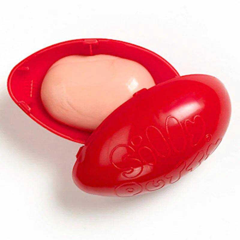 Red, egg-shaped Silly Putty container open to reveal a pale pink putty inside. The word "Silly" is embossed on the lid.