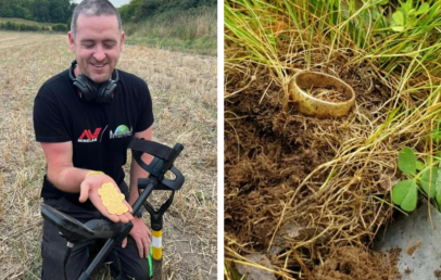 A man in a field holding several gold coins, smiling, with a metal detector next to him. To the right, a close-up of a gold ring partially buried in the grass and soil.