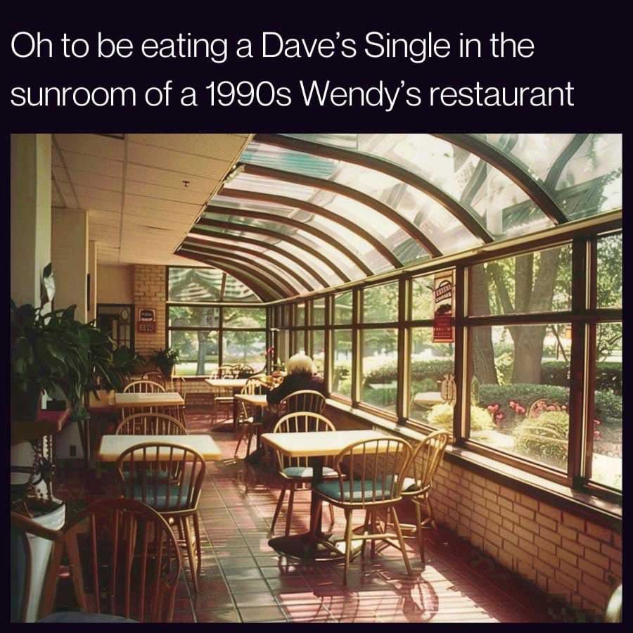 A sunlit seating area in a 1990s Wendy's features wooden tables and chairs near large, arched windows. A few people sit enjoying their meals. The text reflects nostalgia for eating a Dave's Single in this setting.