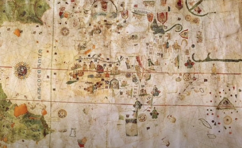 A detailed, colorful ancient map with ornate illustrations and compass roses. Various regions and sea routes are marked, with elaborate depictions of land masses, continents, and creatures. Rich in historical and artistic details.