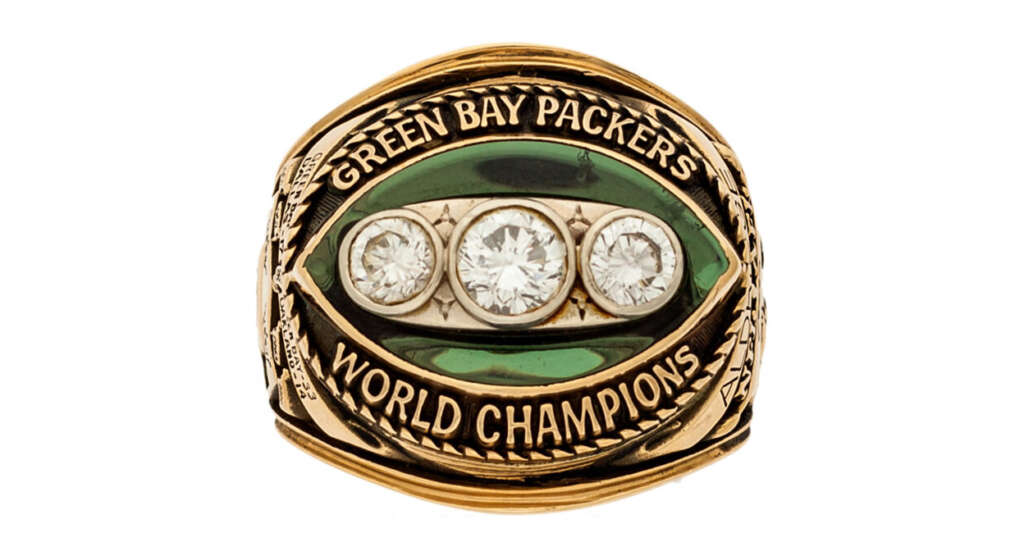 Gold ring with the words "Green Bay Packers" and "World Champions" engraved. The ring features a green football shape with three large diamonds in the center.