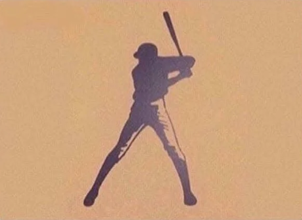 Silhouette of a baseball player in a batting stance against an orange background. The player is holding a bat above their shoulder, with legs apart in a ready position.