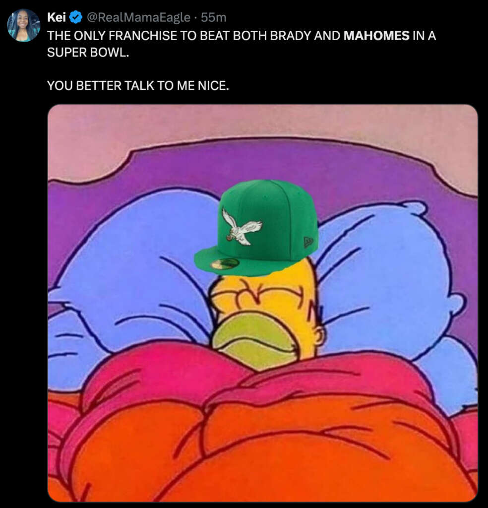 A cartoon character sleeps contentedly under colorful blankets, wearing a green cap with a bird emblem. Above, text states: "THE ONLY FRANCHISE TO BEAT BOTH BRADY AND MAHOMES IN A SUPER BOWL. YOU BETTER TALK TO ME NICE.