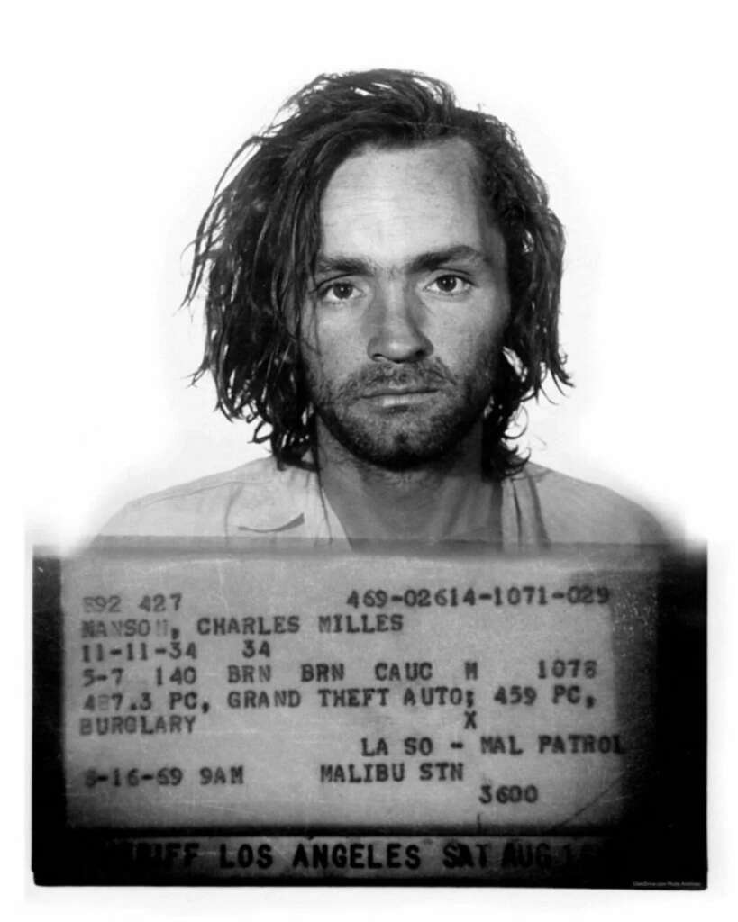 Black and white mugshot of Charles Manson with disheveled hair and a serious expression. Below the photo, there's typed information including name, height, age, and arrest details related to burglary and other charges.