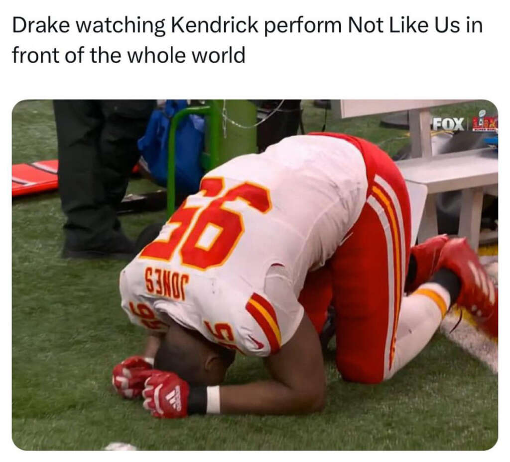 A football player in a white and red uniform kneels on the ground, appearing emotional. The player's helmet is on the ground beside him. Text above reads, "Drake watching Kendrick perform Not Like Us in front of the whole world.