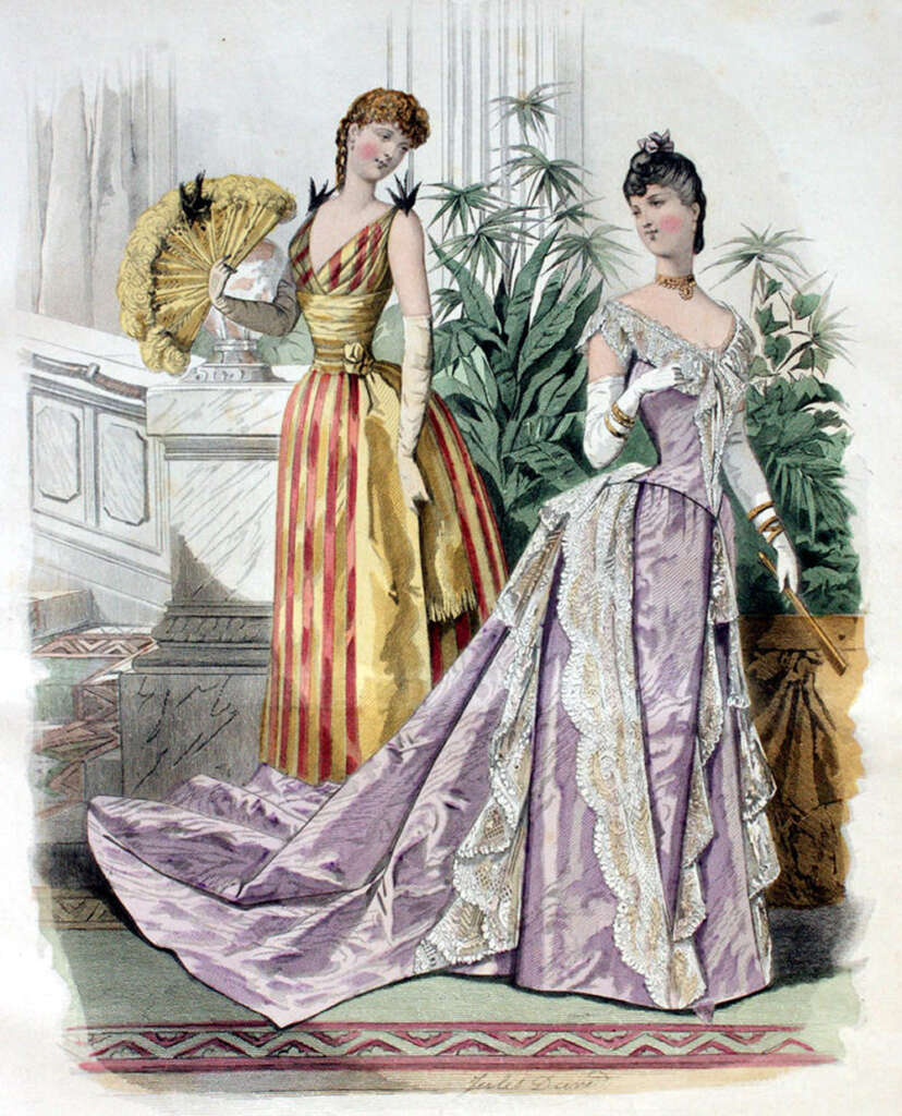 Two women in elegant 19th-century gowns. One wears a striped yellow and red dress with a large fan. The other wears a lavender gown with lace details and a long train. Both have gloves and elaborate hairstyles. Ornate backdrop with plants behind them.