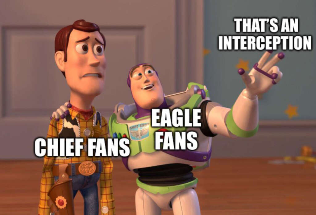 Two animated characters are labeled "Chief Fans" and "Eagle Fans." The "Eagle Fans" character points forward, with text above saying "That's an interception." The "Chief Fans" character looks concerned.