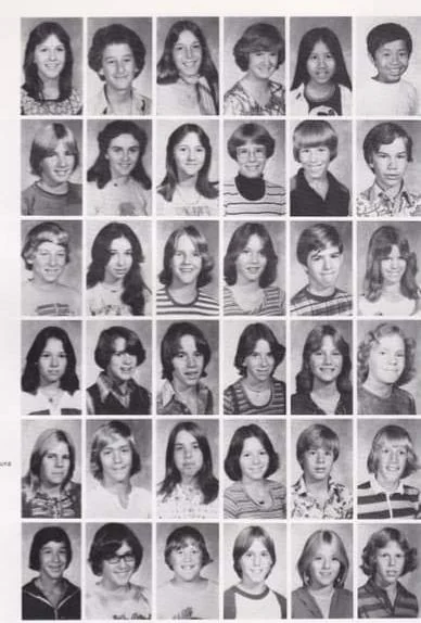 A black and white vintage yearbook page featuring a grid of 35 individual portrait photos of young students. They are arranged in five rows and seven columns, each showing a headshot with different hairstyles and clothing styles from the era.