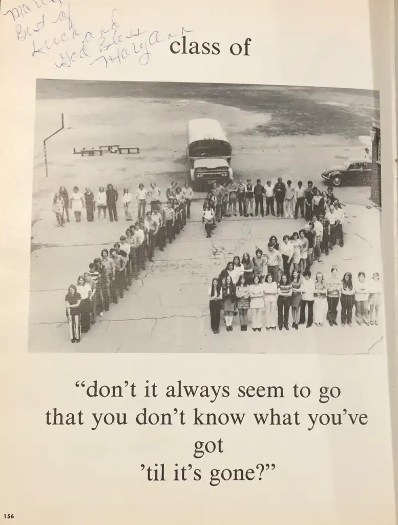 A group of people standing in a field form the word "76". Two school buses and cars are in the background. Above, handwritten text says "class of", and below is the quote, "don’t it always seem to go that you don’t know what you’ve got ’til it’s gone?”