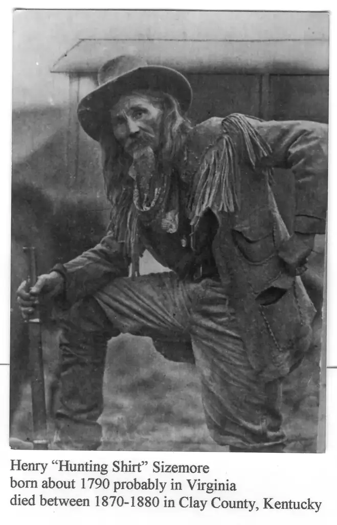 A historical photograph of an older man with a long beard and hat, dressed in fringed attire. He poses confidently with one leg raised. Text below identifies him as Henry "Hunting Shirt" Sizemore, with birth and death details.