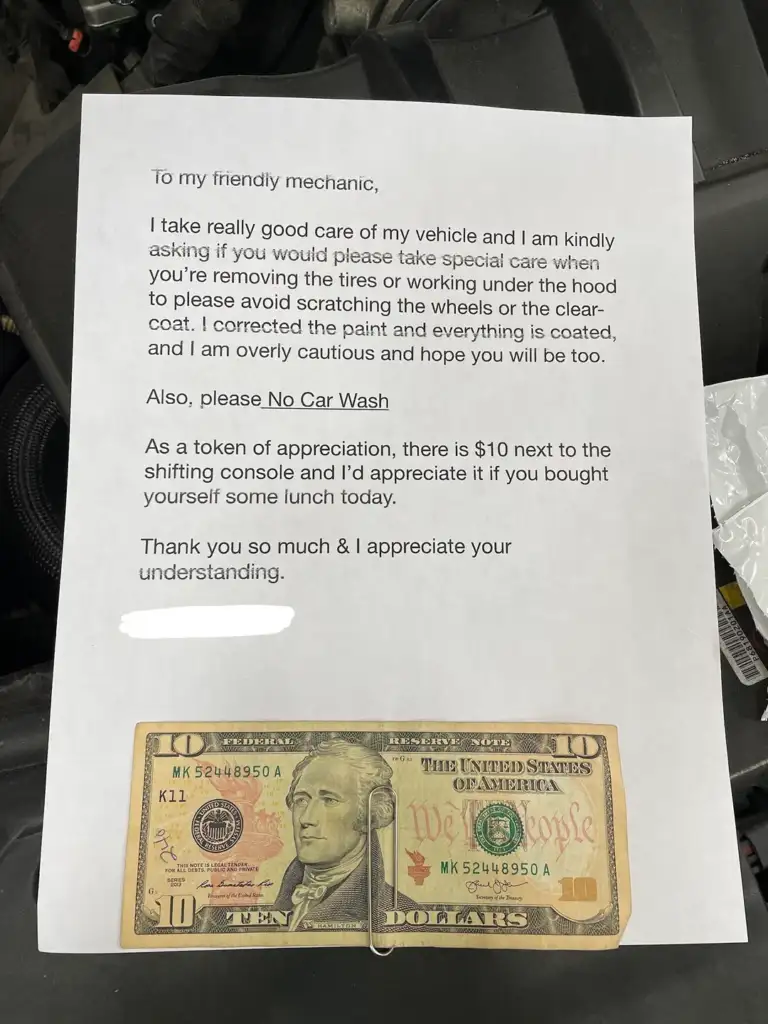 A typed note addressed to a mechanic, requesting careful handling of a vehicle, especially avoiding scratches. It includes a request to skip the car wash. A ten-dollar bill is attached at the bottom as a token of appreciation.