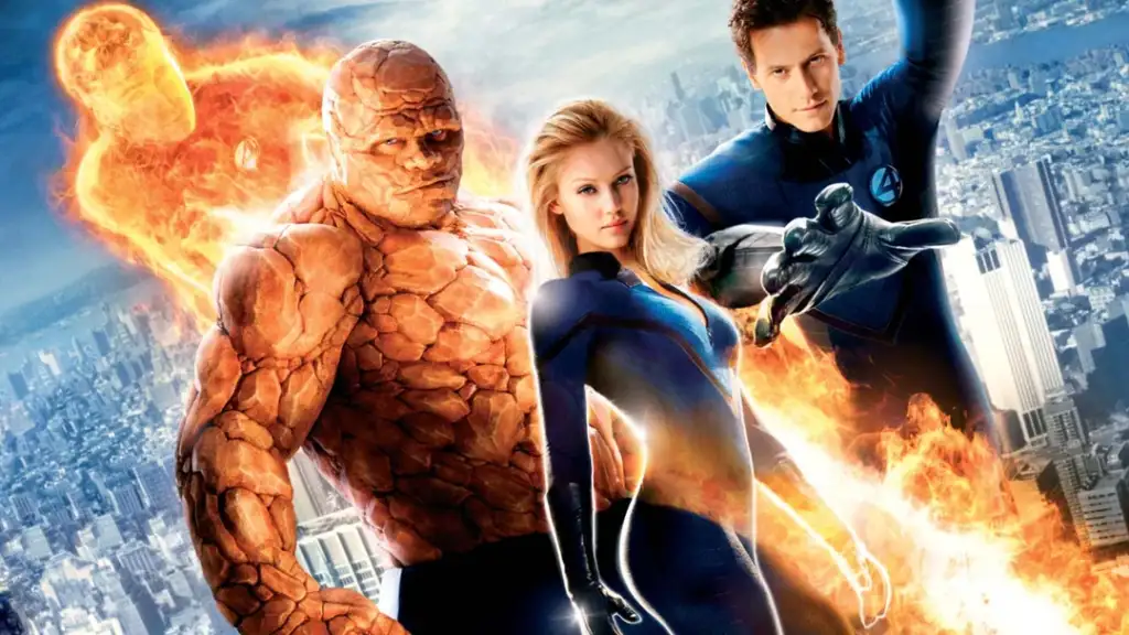 Four superheroes stand on a rooftop overlooking a city skyline. One is flaming, another has a rocky exterior, the third is a woman in a blue suit, and the fourth is a man extending his arm, wearing a suit with a "4" emblem.