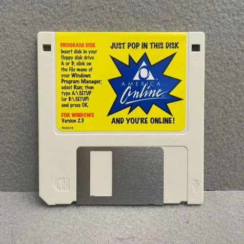 A vintage 3.5-inch floppy disk labeled "America Online" with instructions to insert into a floppy disk drive to access online services. The label is yellow with blue and red text and a starburst graphic.