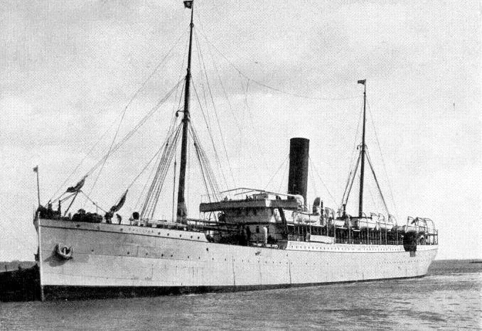 Black and white photo of a vintage steamship on the water. The ship has a tall smokestack and is equipped with multiple lifeboats along its sides. Tall masts rise from the deck, used for rigging and flag display.