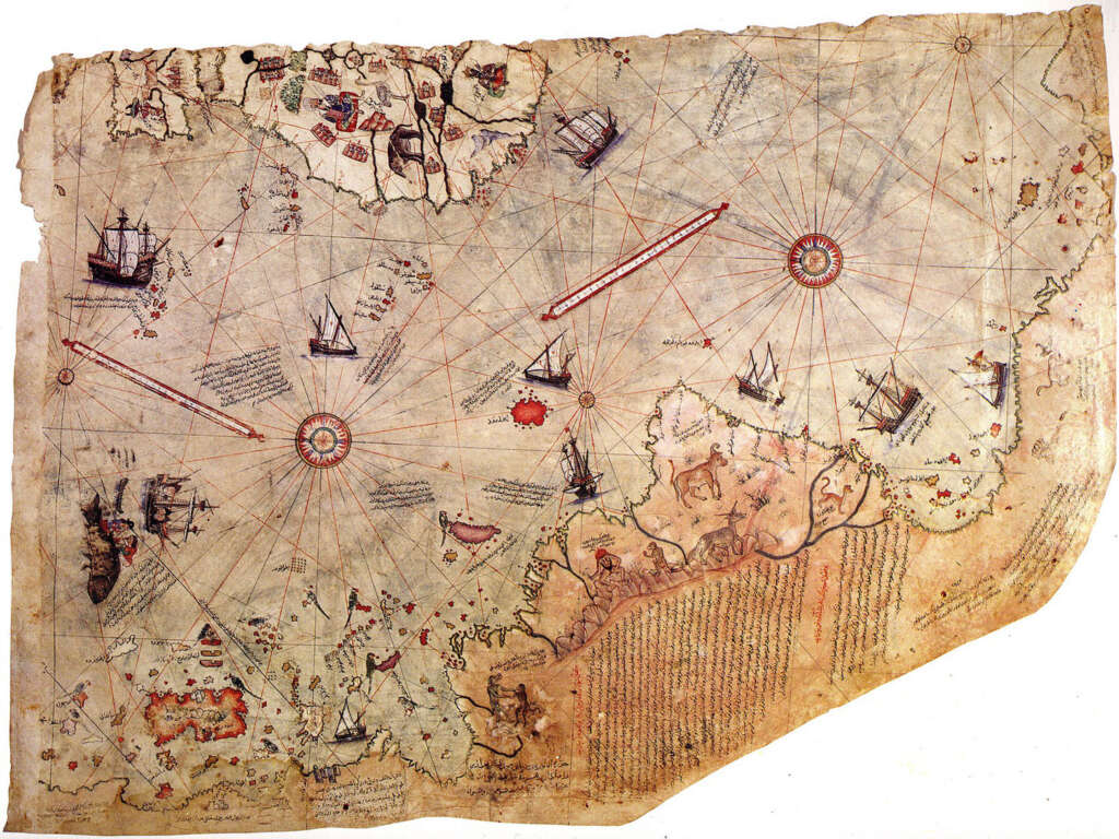 An ancient, weathered map featuring ornate compass roses, several detailed ships on the water, and coastline with varied topography. The map includes hand-drawn embellishments and faded inscriptions in a mix of colors.