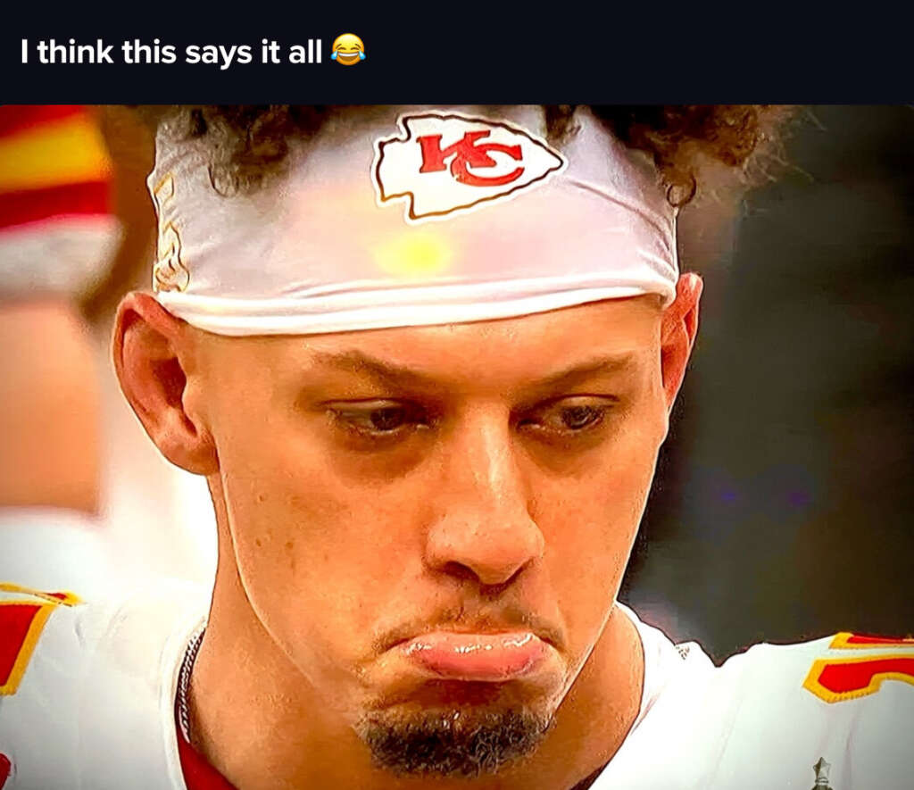 A football player wearing a Kansas City Chiefs headband is making a dramatic pouty face. He appears emotional, with raised eyebrows and a slightly furrowed brow, conveying a playful or exaggerated expression.