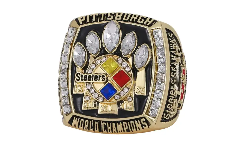 A Super Bowl championship ring with "Pittsburgh" and "World Champions" inscribed. It features diamond decorations and the Steelers logo at the center, along with Roman numerals commemorating championship wins.