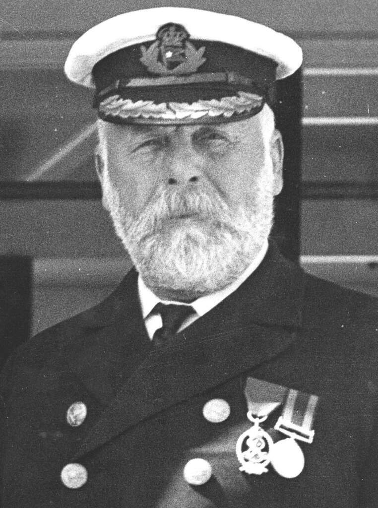 A bearded man in a formal naval uniform and hat. He is wearing medals on his chest and looking directly ahead.