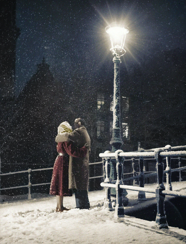 A couple embraces under a streetlamp during a snowy night. They stand on a snow-covered bridge, surrounded by softly falling snowflakes, creating a romantic and serene atmosphere.